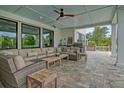 Inviting covered patio with cozy seating, a built-in grill, and an outdoor dining area at 4874 Sound View Dr, Mount Pleasant, SC 29466