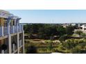 Building exterior with balconies overlooking lush landscaping and trees at 5009 Old Bridgeview Ln # 5009, Charleston, SC 29403