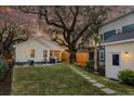 Spacious backyard featuring a well-maintained lawn, patio area, and privacy fence with string lights at 5108 Celtic Dr, North Charleston, SC 29405