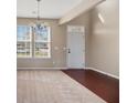 Open living room area featuring neutral paint, lots of light, and a decorative chandelier at 529 Pleasant Side Dr, Moncks Corner, SC 29461