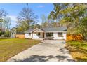 Newly renovated home features painted brick, a modern porch, and a well-maintained front yard at 671 Riley Rd, Charleston, SC 29412