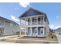 Charming two-story home with a double porch, blue siding, and nicely landscaped yard at 69 Arrowwood Way, Summerville, SC 29485