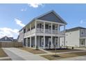 Charming two-story home with a double porch, blue siding, and nicely landscaped yard at 69 Arrowwood Way, Summerville, SC 29485