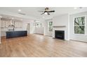 Open-concept living room with a cozy fireplace and modern kitchen with a kitchen island at 712 Minton Rd, James Island, SC 29412