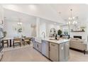 Open-concept living space with a modern kitchen, dining area, and cozy fireplace at 714 Minton Rd, Charleston, SC 29412