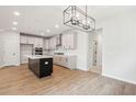 Spacious kitchen with stainless appliances, white cabinets, dark island and wood floors at 724 Minton Rd, Charleston, SC 29412