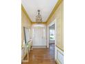 Bright foyer featuring hardwood floors, elegant lighting, mirror and decorative wallpaper at 750 Lakenheath Dr, Mount Pleasant, SC 29464