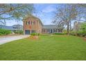 Beautiful brick home on a lush green lot with mature trees and professional landscaping at 750 Lakenheath Dr, Mount Pleasant, SC 29464