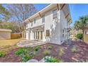 Backyard view featuring a stone patio, landscaped garden beds, and well-maintained exterior at 755 Adluh St, Mount Pleasant, SC 29464