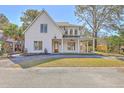 Charming two-story home with wood door, covered porch, and landscaped front yard at 755 Adluh St, Mount Pleasant, SC 29464