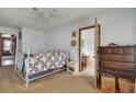 Bedroom with white bed frame, ceiling fan, and doorway leading to the en-suite bathroom at 7560 Cottageville Hwy, Round O, SC 29474