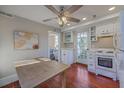Bright, galley kitchen featuring white cabinets and appliances at 10 Humphrey Ct, Charleston, SC 29403