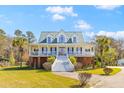 Charming two-story home with a welcoming front porch and well-maintained landscaping at 1008 Hoodtown Rd, Bonneau, SC 29431