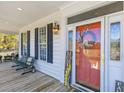 Inviting front porch with comfortable seating and charming decor at 1008 Hoodtown Rd, Bonneau, SC 29431