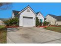 Home featuring long driveway leading to garage, tidy lawn and landscaping at 101 Dovetail Cir, Summerville, SC 29483
