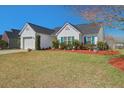 Beautiful white-sided home with blue shutters and well-manicured lawn at 101 Dovetail Cir, Summerville, SC 29483