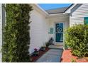 Close up view of home's front door, adorned with lush green plantings at 101 Dovetail Cir, Summerville, SC 29483