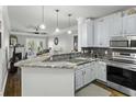 Well-lit kitchen featuring granite countertops, stainless steel appliances and ample cabinet space at 1025 Riverland Woods Pl # 609, Charleston, SC 29412