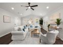 Bright living room with a vaulted ceiling, hardwood floors, and large windows that illuminate the space at 112 Robin Ct, Summerville, SC 29485