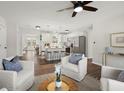 Bright open concept living room with modern decor, hardwood floors, and a view into the kitchen at 112 Robin Ct, Summerville, SC 29485
