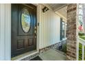 Elegant front door featuring decorative glass, complemented by brick accents and a secure smart lock system at 115 Clubhouse Rd, Summerville, SC 29483