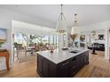Bright, open-concept kitchen with a large center island, modern pendant lighting, and views of the scenic outdoors at 1456 Mcpherson Lndg, Johns Island, SC 29455