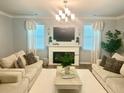 Cozy living room with a fireplace, comfortable seating, and ample natural light, perfect for relaxation at 150 Haverhill St, Summerville, SC 29486