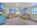 Living room with comfortable couches, ceiling fan, and natural light creating an inviting atmosphere at 1644 Cooper Store Rd, Moncks Corner, SC 29461