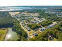 Aerial view of new construction homes in a lovely neighborhood surrounded by mature trees and a pond at 1690 Cultivation Ln # 543, Mount Pleasant, SC 29466