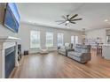 Open-concept living room with a fireplace, hardwood floors, and lots of natural light at 175 Darby Meadow Ln, Ridgeville, SC 29472