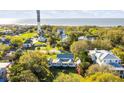 Expansive aerial view of the property, showcasing its lush landscape and proximity to the historic lighthouse at 1808 Ion Ave, Sullivans Island, SC 29482