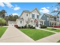 Two-story home with a manicured lawn and inviting front porch that enhances the home's curb appeal at 182 Callibluff Dr, Summerville, SC 29486