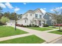 Two-story home with a manicured lawn and inviting front porch that enhances the home's curb appeal at 182 Callibluff Dr, Summerville, SC 29486