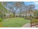 Expansive backyard with a well-maintained lawn, trees, and a fire pit for outdoor enjoyment at 202 Crestwood Dr, Summerville, SC 29483