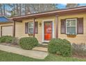 Inviting home exterior featuring a cozy front porch, lush landscaping, and charming details at 202 Crestwood Dr, Summerville, SC 29483