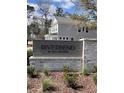 Entrance to the 'Riverbend by Toll Brothers' neighborhood with brick and wood sign at 2022 Riverbend Dr, Charleston, SC 29412