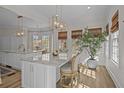 Beautiful kitchen island with marble countertop, seating, and pendant lighting at 2041 Ashburton Way, Mount Pleasant, SC 29466