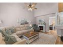 Inviting living room featuring vaulted ceiling, a cozy fireplace, and comfortable seating at 205 Yellow Hawthorn Cir, Summerville, SC 29483