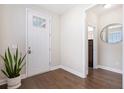 Bright foyer featuring hardwood floors, a stylish mirror, and a white front door at 207 Billinger St, Summerville, SC 29486