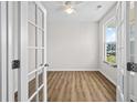 Bright office space with wood floors, a ceiling fan, a glass door, and a large window that provides lots of natural light at 2150 Pimlico Dr, Ridgeville, SC 29472