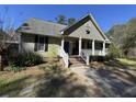 Inviting home exterior with a covered porch, brick walkway, and beautiful landscaping at 2164 Highway 78, Dorchester, SC 29437
