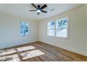 Bright bedroom with hardwood floors, a ceiling fan, and two large windows offering natural light at 2314 Kent Ave, North Charleston, SC 29405