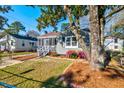 Charming home featuring a screened-in porch and beautifully landscaped front yard with colorful flowers at 2314 Kent Ave, North Charleston, SC 29405