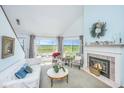 Cozy living room with fireplace, marsh views, and plenty of natural light at 242 Little Oak Dr, Folly Beach, SC 29439