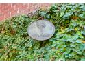 Charming welcome sign adorned with greenery on a brick wall, creating a warm invitation at 2707 Waterpointe Cir, Mount Pleasant, SC 29466