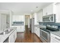Modern kitchen with stainless steel appliances, granite countertops, and white cabinets at 2917 Swamp Sparrow Cir, Johns Island, SC 29455
