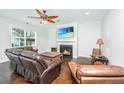 Comfortable living room with a fireplace, a ceiling fan, and inviting leather furniture at 2917 Swamp Sparrow Cir, Johns Island, SC 29455