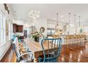 Open dining room with hardwood floors, stylish chandelier, and views into the gourmet kitchen at 3006 Cameron Blvd, Isle of Palms, SC 29451