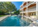 Enjoy a 25,000-gallon saltwater pool (38' x 26') in this beautiful backyard setting with inviting outdoor space at 3006 Cameron Blvd, Isle of Palms, SC 29451