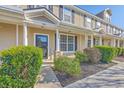 Attractive townhouse featuring manicured bushes, covered porch, and a welcoming front entrance at 309 Hemingway Cir, Summerville, SC 29483